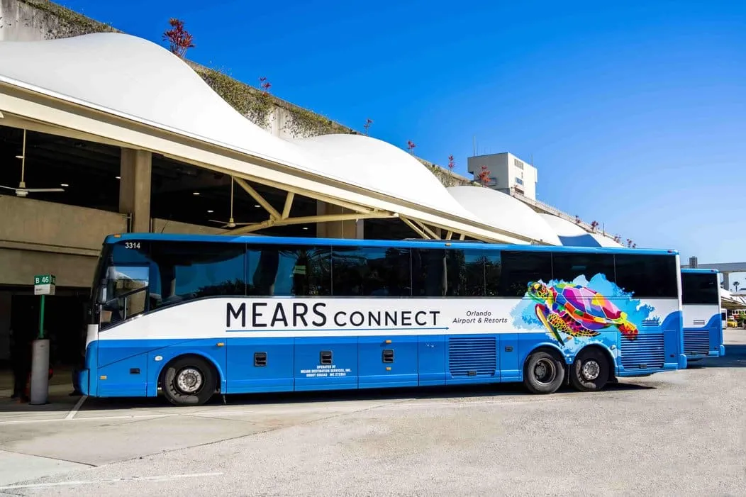 a blue bus parked in front of a building