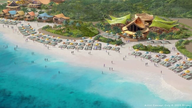 a beach with a resort and a group of people