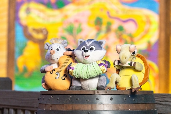 a group of stuffed animals on a barrel