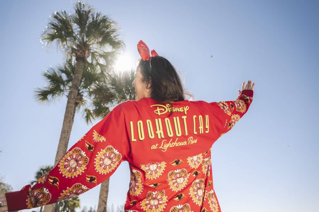 a woman wearing a red shirt with a red headband and ears