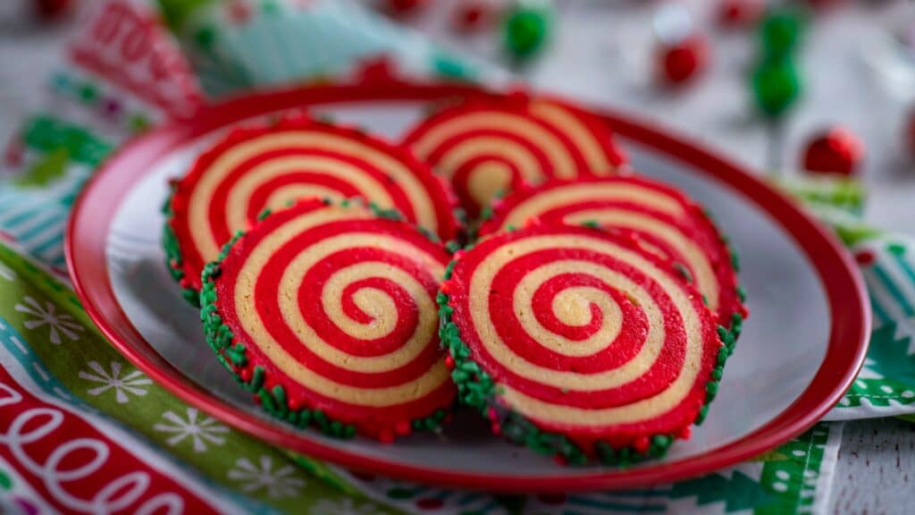 a plate of cookies with red and white swirls