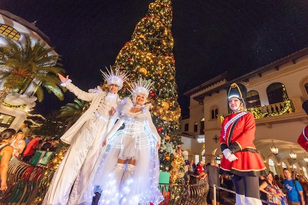 a group of people in clothing and a christmas tree